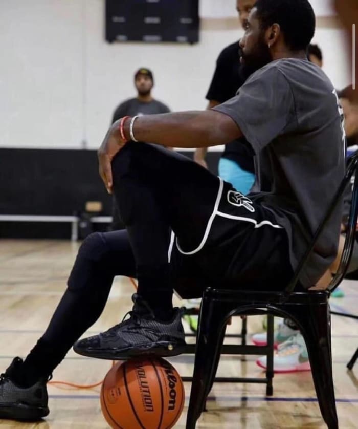 Kyrie Irving looks on during a basketball game.